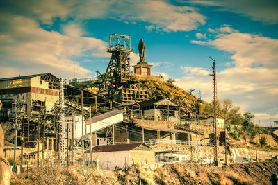 Low angle view of factory against sky