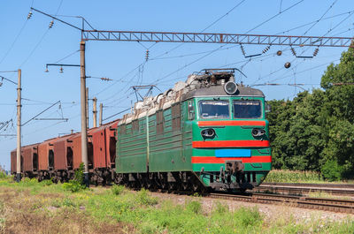 Train on railroad track against clear sky