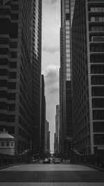 Street amidst buildings in city against sky