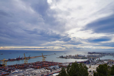High angle view of harbor by buildings in city against sky