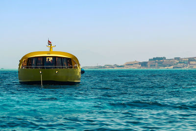 Boat in sea against buildings in city