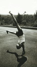 Full length of woman standing by railing