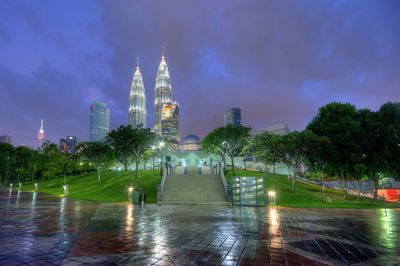 View of illuminated buildings against cloudy sky