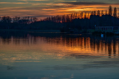 Scenic view of lake against orange sky