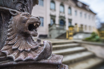 Close-up of statue against building in city