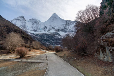 Road amidst against snowcapped mountains