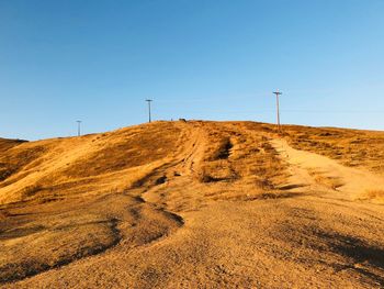 Scenic view of land against clear blue sky