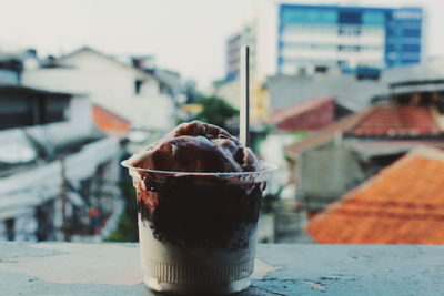 Close-up of dessert in glass on retaining wall