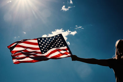 Low angle view of flag against sky on sunny day