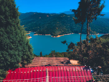 Scenic view of trees and buildings against blue sky