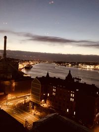 High angle view of illuminated buildings against sky at sunset