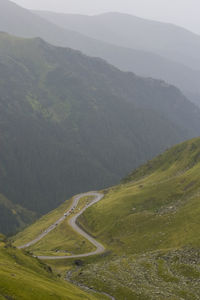 Winding road in valley against mountains