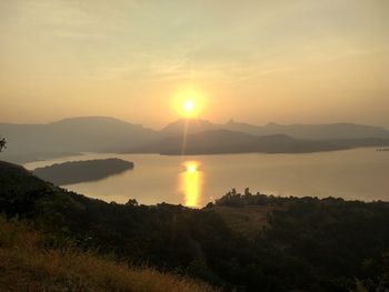 Scenic view of lake against sky during sunset