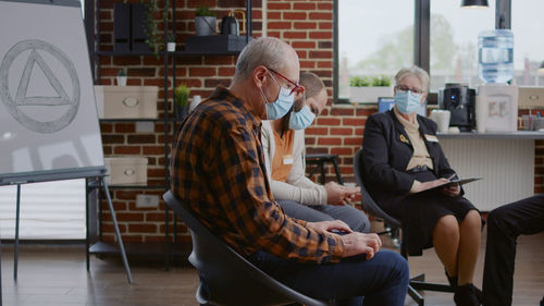 People wearing mask attending psychotherapy session