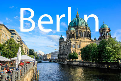 Panoramic view of river amidst buildings in city