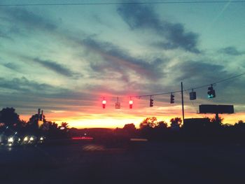 Traffic on road at sunset