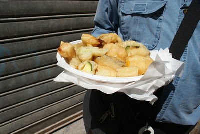 Low section of man holding food