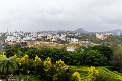 City at the foothill of misty mountain layer at morning from flat angle