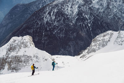 Rear view of man skiing on snowcapped mountain