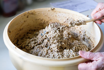 Close-up of person preparing food in bowl