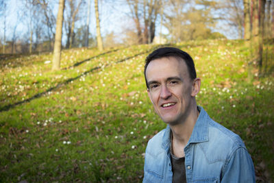 Portrait of young man standing on field