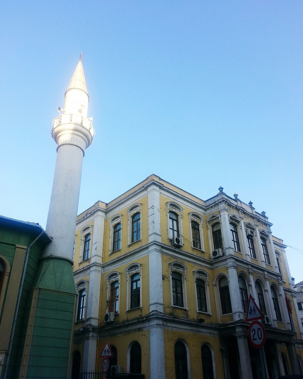 architecture, building exterior, built structure, low angle view, clear sky, blue, history, travel destinations, copy space, arch, window, facade, famous place, city, sky, day, outdoors, architectural column, tower, tourism