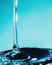 Close-up of water drop against blue background
