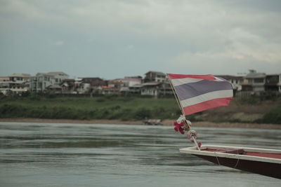 Boat on river against sky