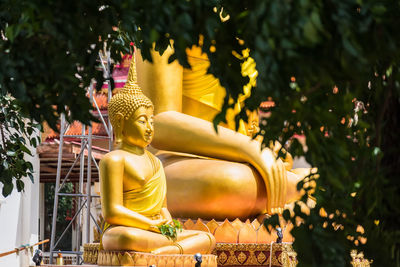 Statue of buddha against building