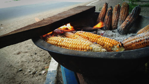 Close-up of corns on fire pit