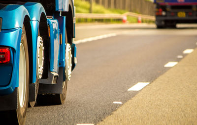 View of blue car on road