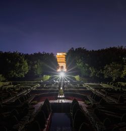 Illuminated built structure against clear sky at night