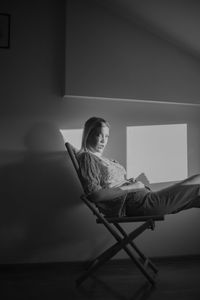 A young woman posing in studio during sunset