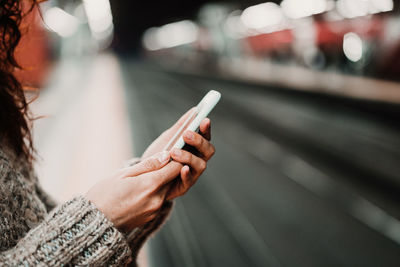 Midsection of woman using mobile phone