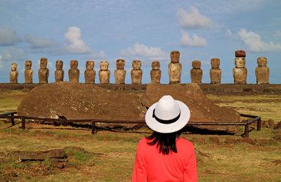 Rear view of woman wearing hat while looking at monuments