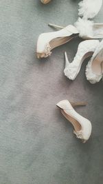 High angle view of white high heels on table