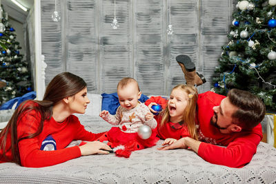 Family sitting on sofa at home