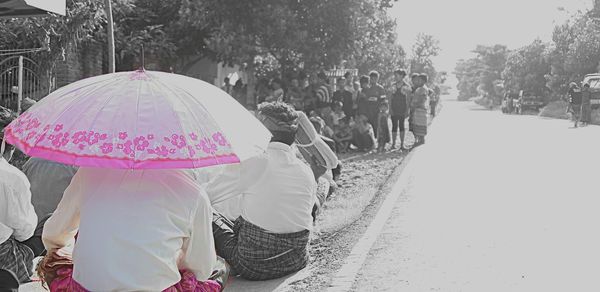 Man with pink umbrella