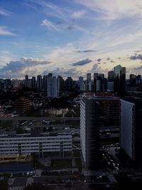 View of cityscape against cloudy sky