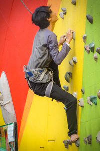 Full length of boy on yellow wall