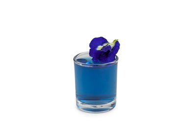Close-up of blue glass against white background