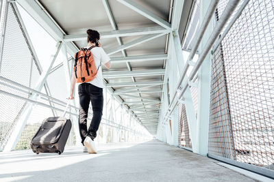 Low angle view of man walking on footpath