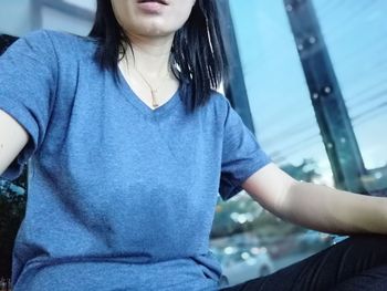 Close-up of teenage girl sitting outdoors