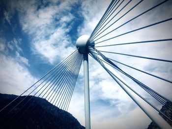 Low angle view of suspension bridge against sky