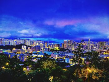 High angle view of city lit up at night