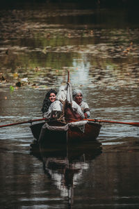 Men sitting on boat sailing in river