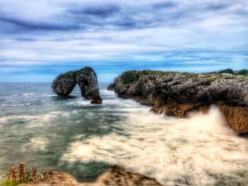 Rocks in sea against sky