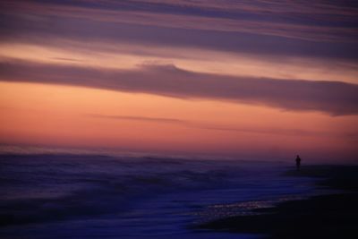 Scenic view of sea against orange sky