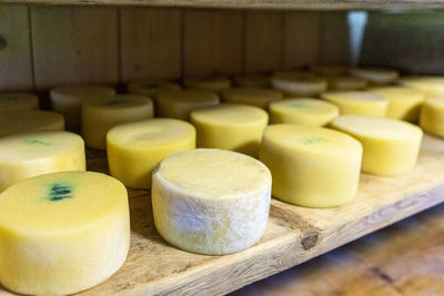 Wheels of cheese maturing 