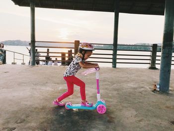Full length of cute girl riding motorcycle